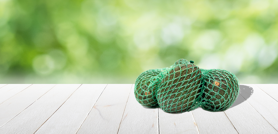 Avocados packed in a net bag with clip using a C-pack net clipper, sustainable and efficient avocado packaging solution