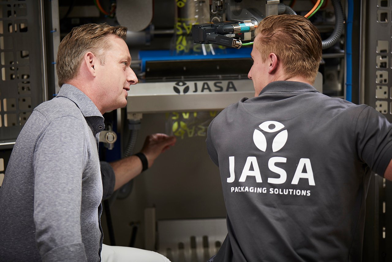 Contact JASA for packaging solutions – technical experts discussing innovative packaging machines