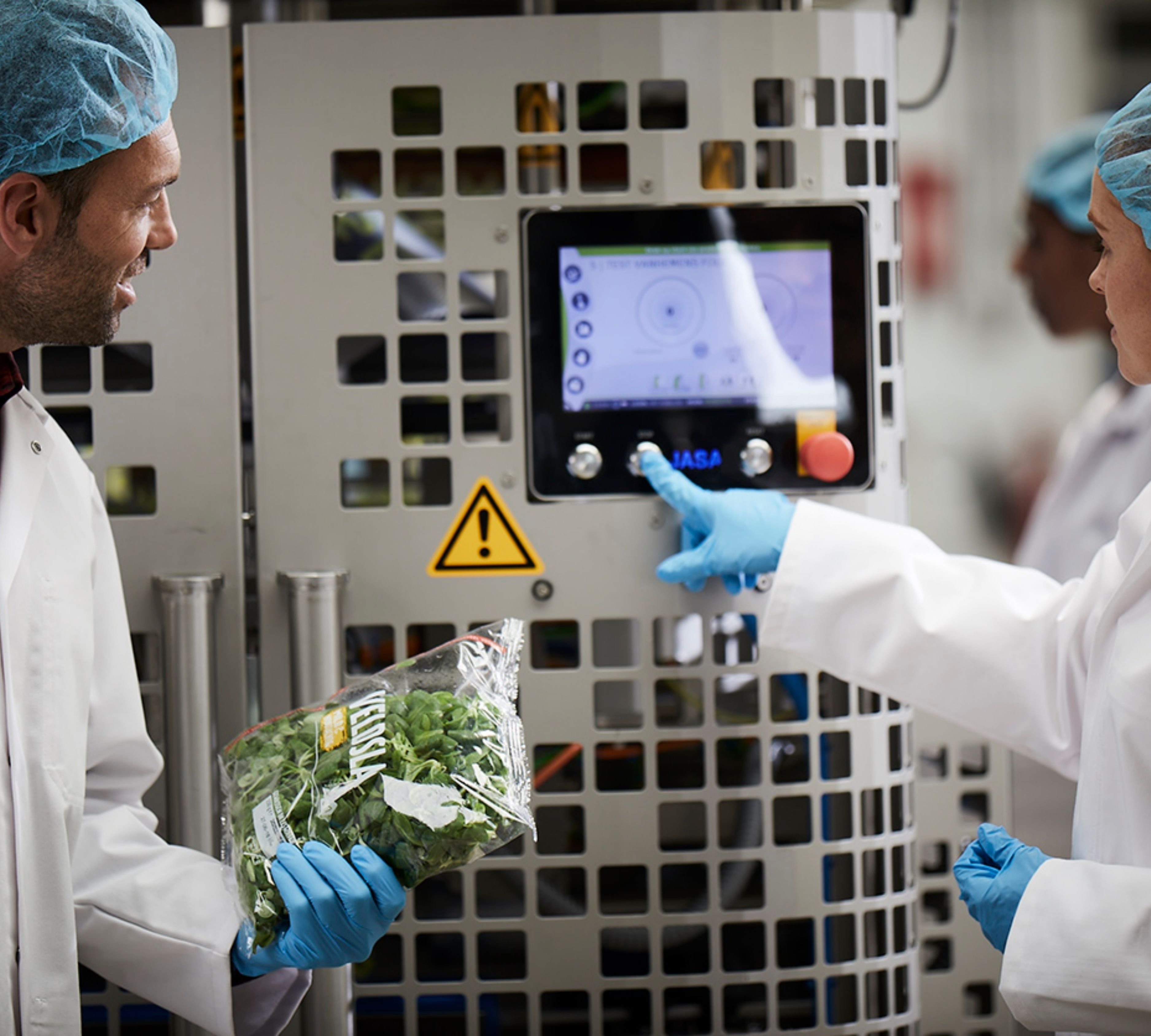 JASA operator monitoring leafy greens packaging line with integrated control system
